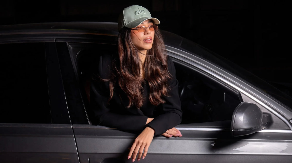 Leaning out of a car window in Raithe sunglasses